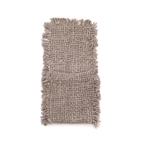 A textured, rectangular woven fabric swatch in a neutral beige tone, featuring fringed edges and a rough, irregular surface. This unique textile product appears handmade, showcasing a natural and rustic aesthetic perfect for cutlery holders in a luxurious table setting.