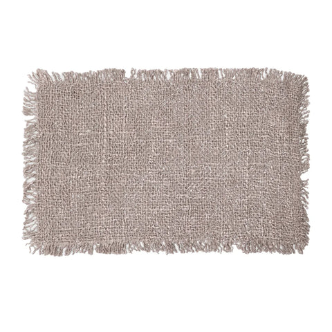 A rectangular area rug with a hand-dyed, luxurious texture in light brown features fringed edges on all sides. The rug has an earthy, natural appearance, making it suitable for rustic or casual decor settings.