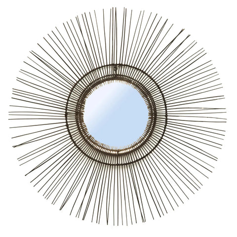 A decorative round mirror with a sunburst design features thin, metallic rods radiating outward from the central mirror, creating a star-like pattern. With its symmetrical and modern aesthetic, this 70s inspired mirror adds a vintage yet chic touch to any space.