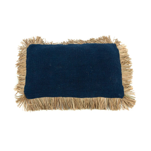 A rectangular navy blue pillow with boho Raffia fringed edges, perfect for a villa-style home.