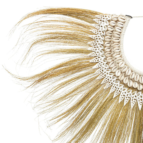 This bohemian beauty boasts a decorative necklace with hand-placed shells and a fringe of long, golden-brown fibers. The intricate design includes detailed white beadwork, elegantly forming a fan-like shape, perfect for enhancing any rayung grass display.