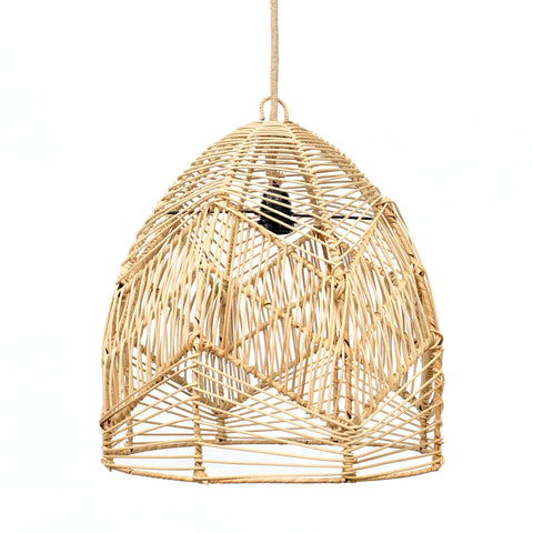 A handcrafted rattan pendant light hangs from the ceiling. Its dome shape features an intricate, geometric pattern with diagonal and vertical lines, offering glimpses of the bulb inside. This boho lamp's natural color gives it an earthy and minimalist look.