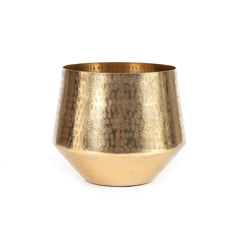 A brass planter boasting a rich, hammered texture shines warmly with its slightly tapered base. Empty and set against a plain white background, it exudes elegance.