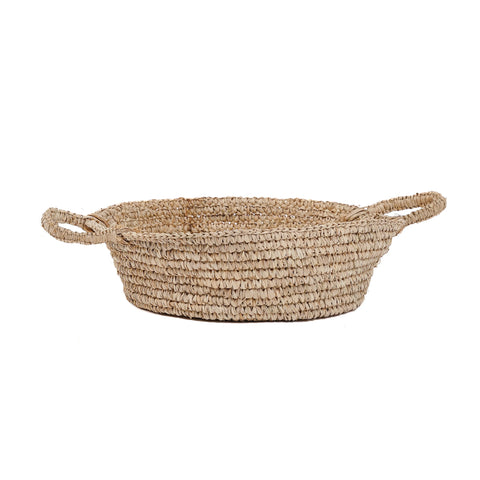 A round, woven raffia basket with two loop handles on each side. This light brown basket features a tightly knit pattern, perfect for multipurpose use in your home interior.