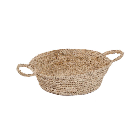 A round raffia basket with two handles, made from natural materials. Light brown and sturdy, it's perfect for multipurpose use, whether holding items or as a decorative piece enhancing your home interior.