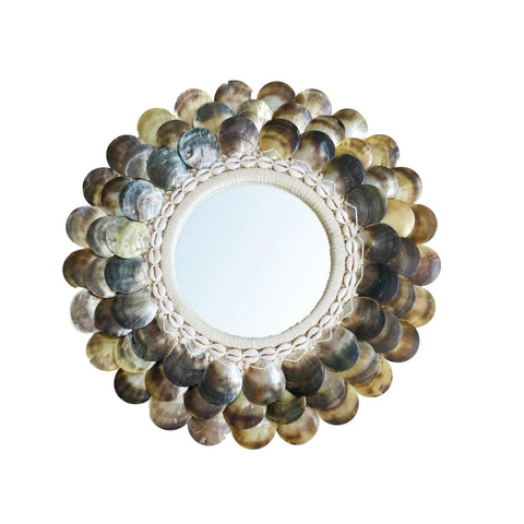 This coastal wall mirror features a decorative round design with a frame of layered, overlapping multi-colored capiz shells. The shimmering effect and circular pattern around the mirror lend an elegant, natural touch perfect for boho chic styling.