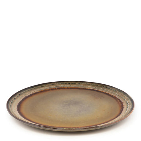 This handmade tableware piece boasts a rustic design, featuring earthy tones of beige, brown, and green with a subtle textured pattern around the rim. Embracing the essence of Portuguese ceramics, its matte finish and slightly curved surface highlight its unique design.